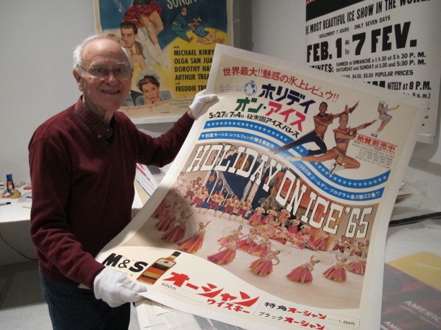 Roy Blakey holding up a 1965 Holiday on Ice poster in a photo for the manleywoman skatecast, a figure skating podcast