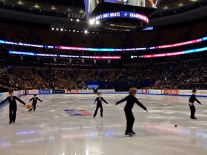 Boy sweepers and US Figure Skating Nationals in a photo for for the manleywoman skatecast, a figure skating podcast