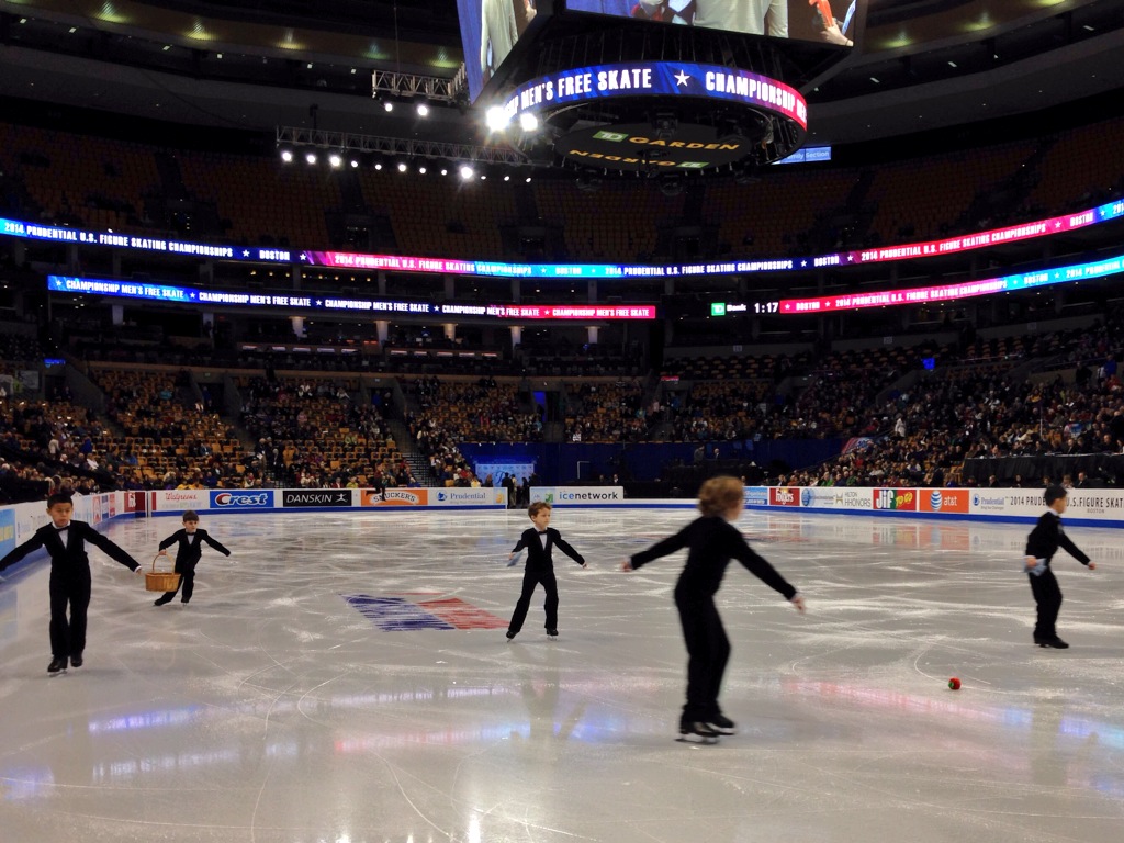 Boy sweepers and US Figure Skating Nationals in a photo for for the manleywoman skatecast, a figure skating podcast