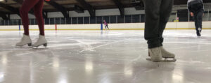image of skater's boots and feet on an ice surface, for the manleywoman skatecast, a figure skating podcast
